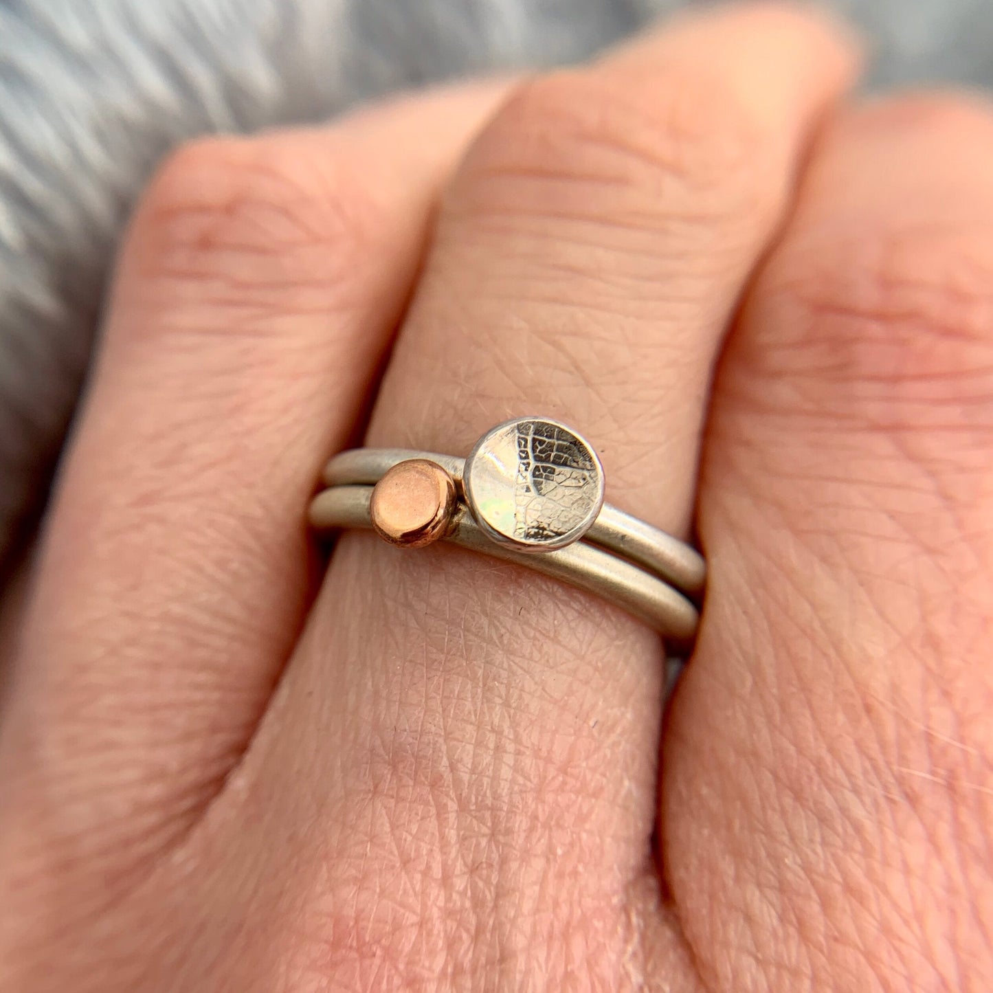 Kate Phipps Jewellery Domed circles ring small leaf skeleton textured silver stacked with 9 carat rose gold nugget ring model photo