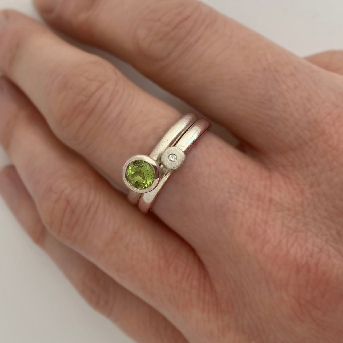 Kate Phipps Jewellery Stacking rings nugget diamond and silver stacked with peridot scattered trillions ring model photo