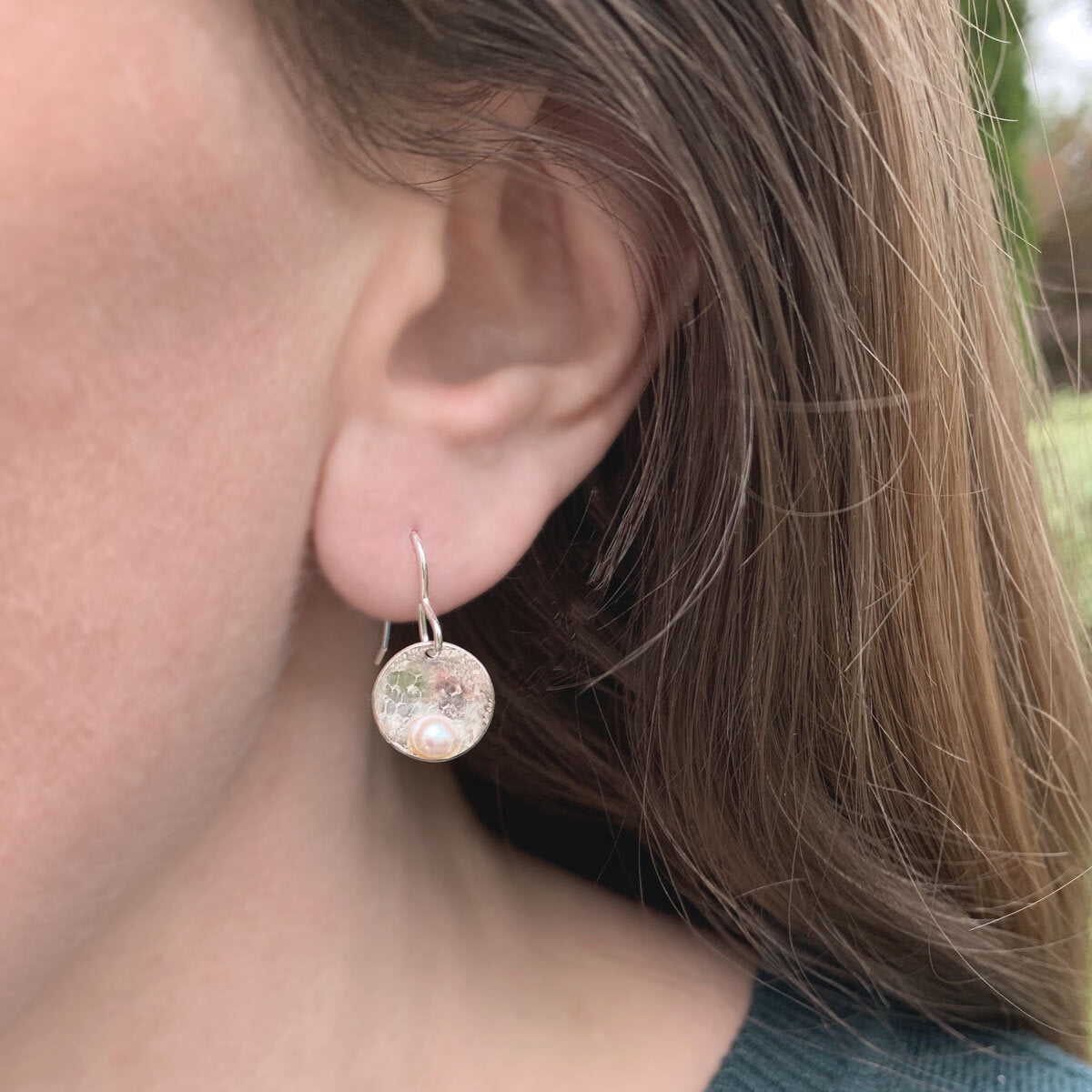 Kate Phipps Jewellery Domed circles drop earrings lace textured silver with white pearl model photo