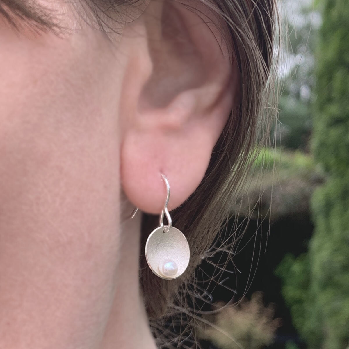 Kate Phipps Jewellery Domed circles drop earrings satin finish silver with white pearl model photo