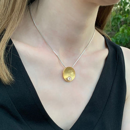 Kate Phipps Jewellery Domed circles necklace leaf skeleton textured 22 carat yellow gold plated silver with white pearl model photo product photo