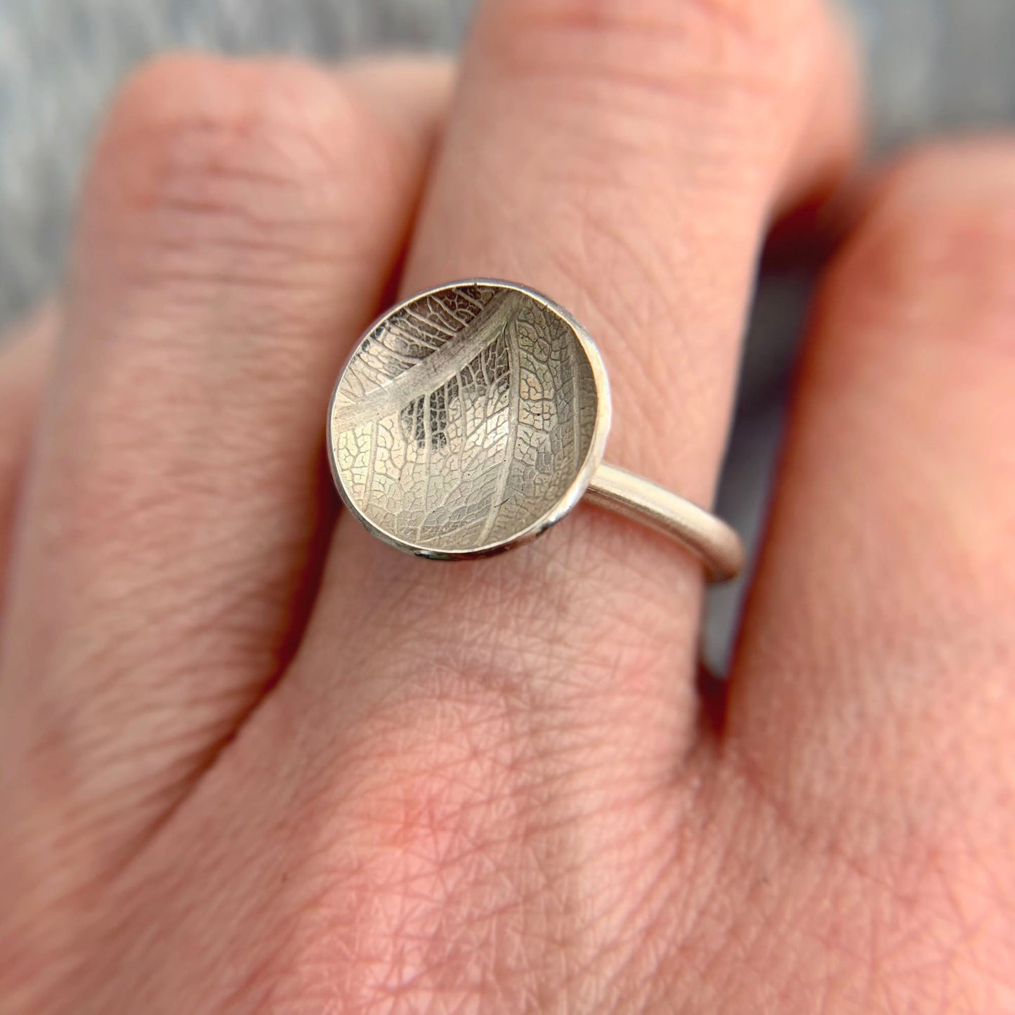 Kate Phipps Jewellery Domed circles ring large leaf skeleton textured silver model photo