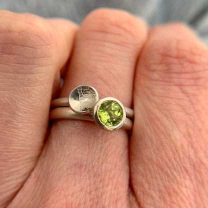 Kate Phipps Jewellery Domed circles ring small leaf skeleton textured silver stacked with scattered trillions peridot and silver ring model  photo