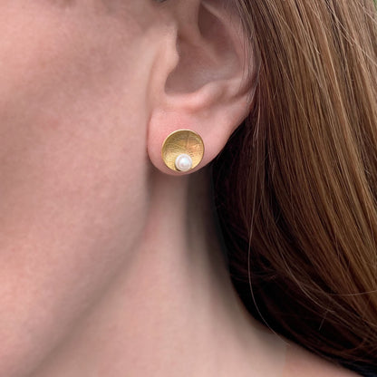 Kate Phipps Jewellery Domed circles stud earrings large 22 carat yellow gold plated silver leaf skeleton textured with white pearl model photo