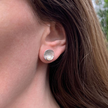 Kate Phipps Jewellery Domed circles stud earrings large lace textured silver with white pearl model photo