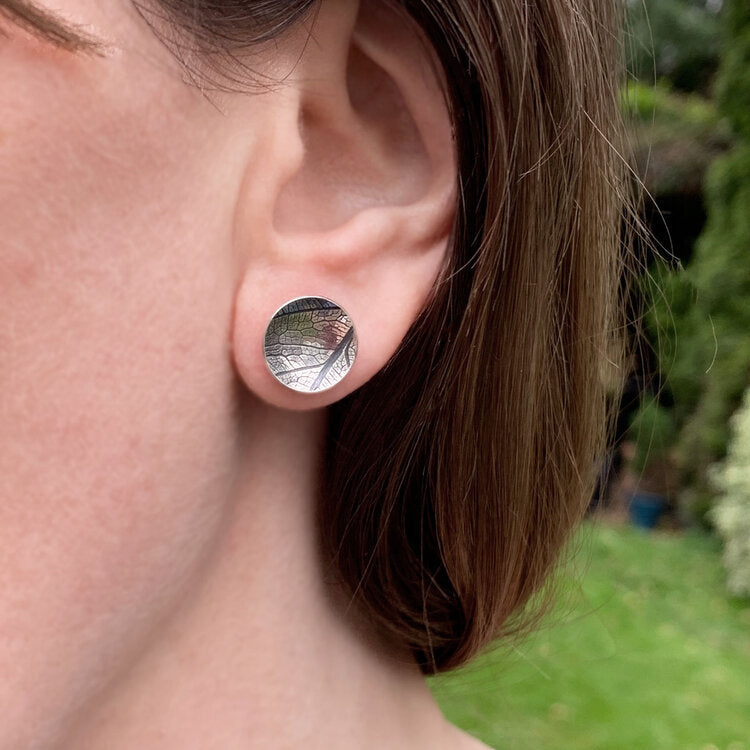 Kate Phipps Jewellery Domed circles stud earrings large oxidised leaf skeleton textured silver model photo