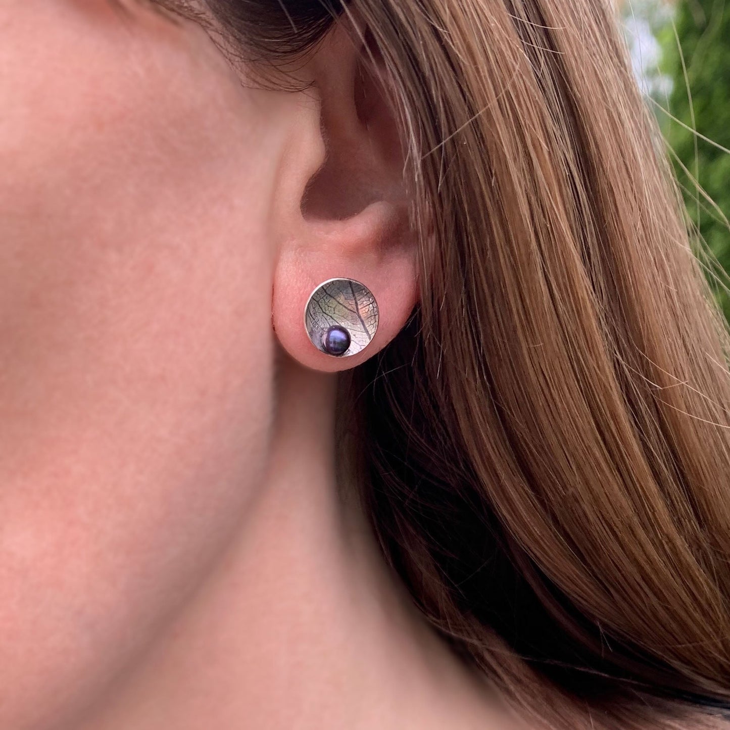Kate Phipps Jewellery Domed circles stud earrings large oxidised leaf skeleton textured silver with peacock pearl model photo