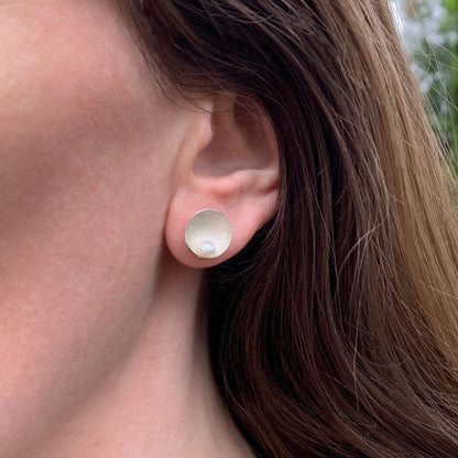 Kate Phipps Jewellery Domed circles stud earrings large satin finish silver with white pearl model photo