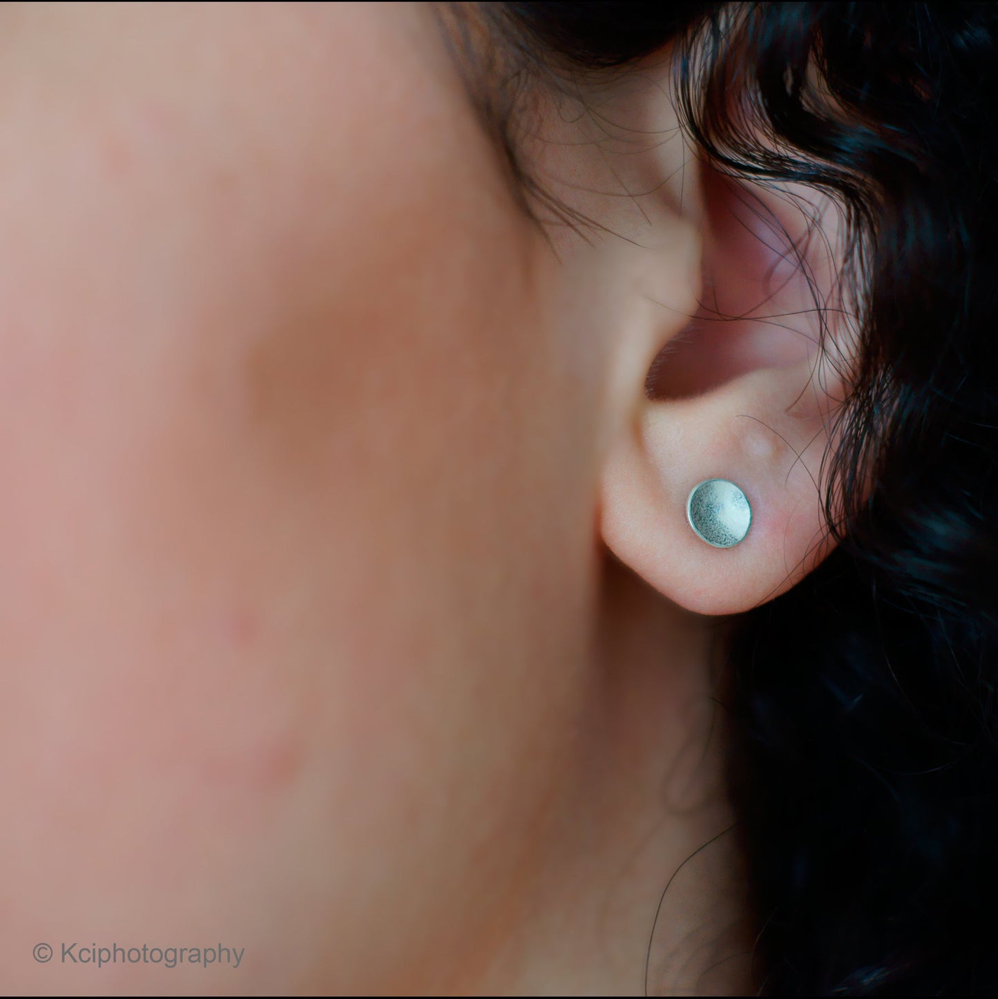 Kate Phipps Jewellery Domed circles stud earrings small subtle polished finish silver model photo