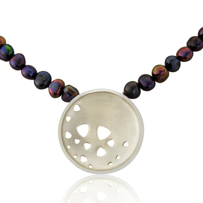 Kate Phipps Jewellery Scattered trillions necklace large silver pendant on peacock pearl beads close up