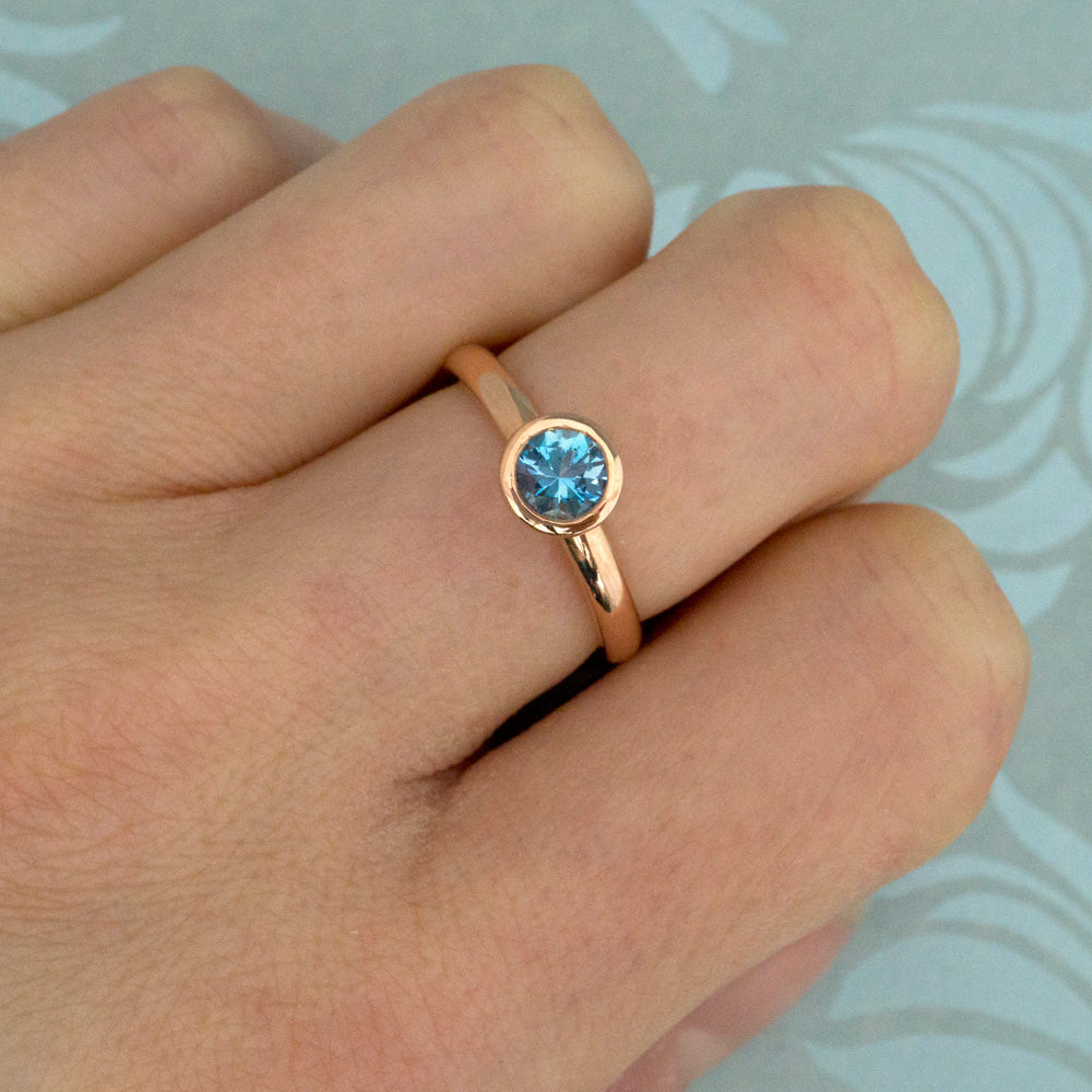 Kate Phipps Jewellery Scattered trillions ring 9 carat solid rose gold with dark aquamarine model photo 1