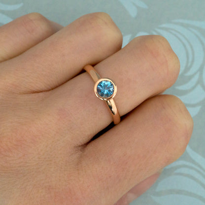 Kate Phipps Jewellery Scattered trillions ring 9 carat solid rose gold with dark aquamarine model photo 1