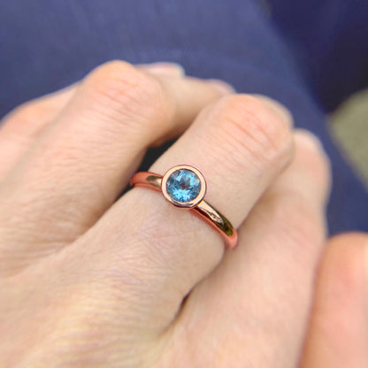 Kate Phipps Jewellery Scattered trillions ring 9 carat solid rose gold with dark aquamarine model photo 2