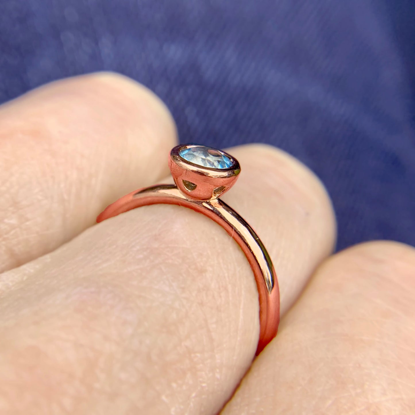 Kate Phipps Jewellery Scattered trillions ring 9 carat solid rose gold with dark aquamarine model photo 3