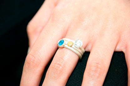 Kate Phipps Jewellery Scattered trillions ring and nugget ring silver with turquoise blue cubic zirconia and clear cubic zirconia and 18 carat yellow gold nugget and silver ring model