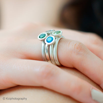 Kate Phipps Jewellery Scattered trillions ring silver with blue and green stones side on model  photo  