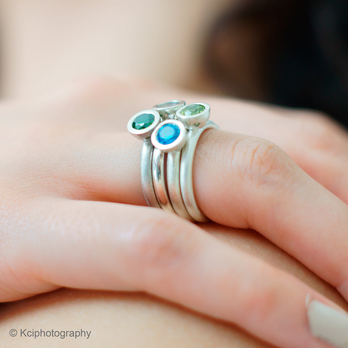 Kate Phipps Jewellery Scattered trillions ring silver with blue and green stones side on model  photo  