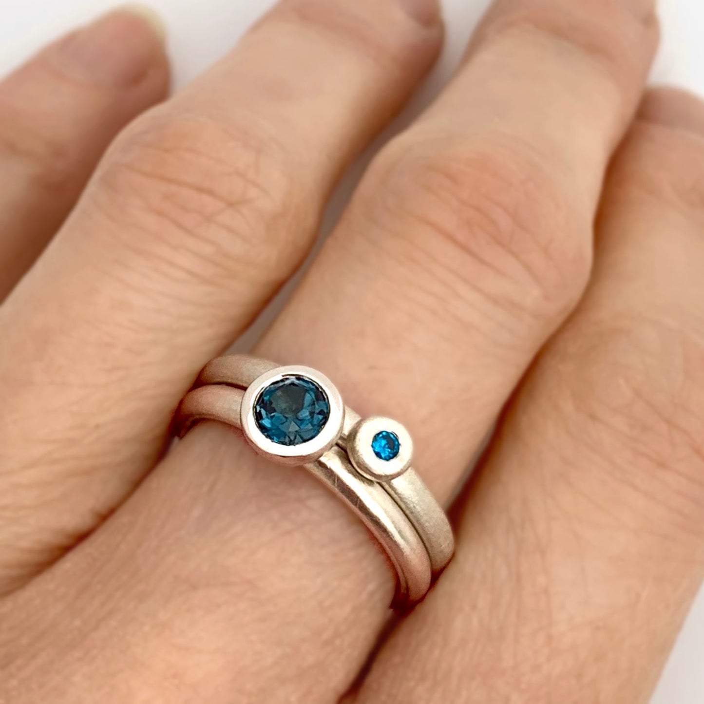 Kate Phipps Jewellery Scattered trillions ring with London blue topaz in silver and silver nugget ring with turquoise cubic zirconia model  photo