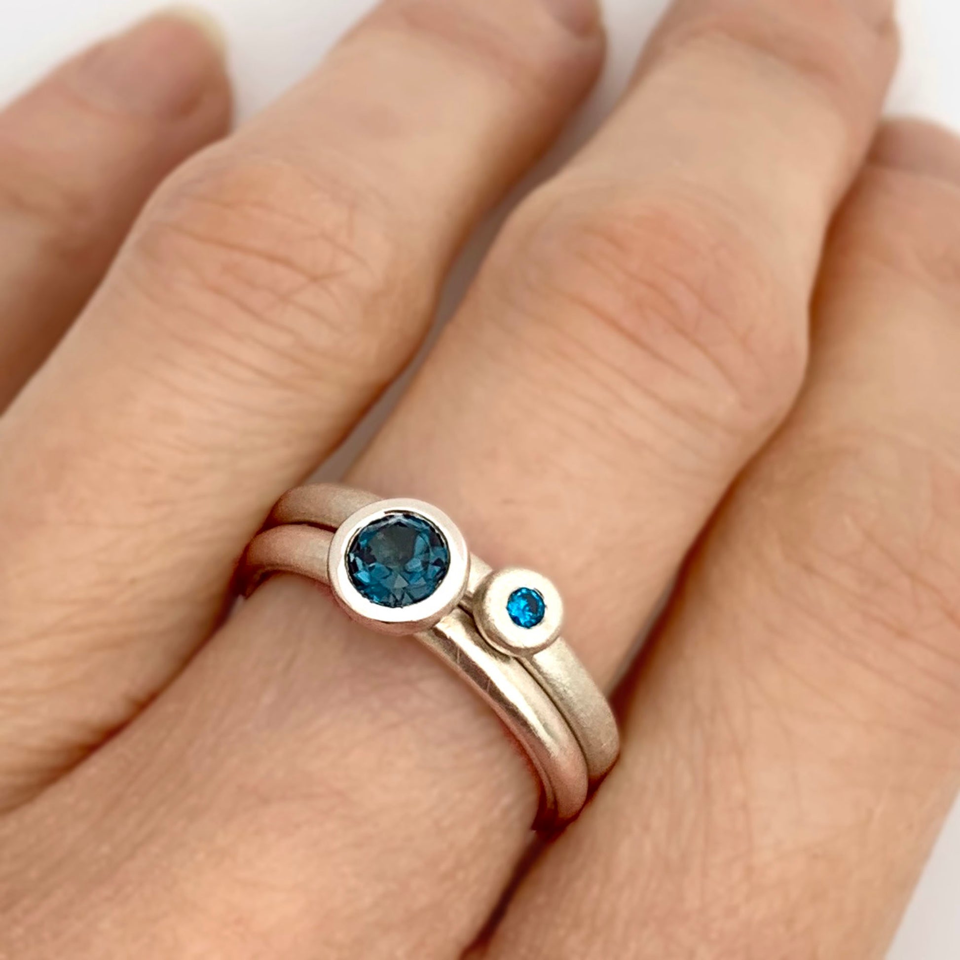 Kate Phipps Jewellery Scattered trillions ring with London blue topaz in silver and silver nugget ring with turquoise cubic zirconia model  photo