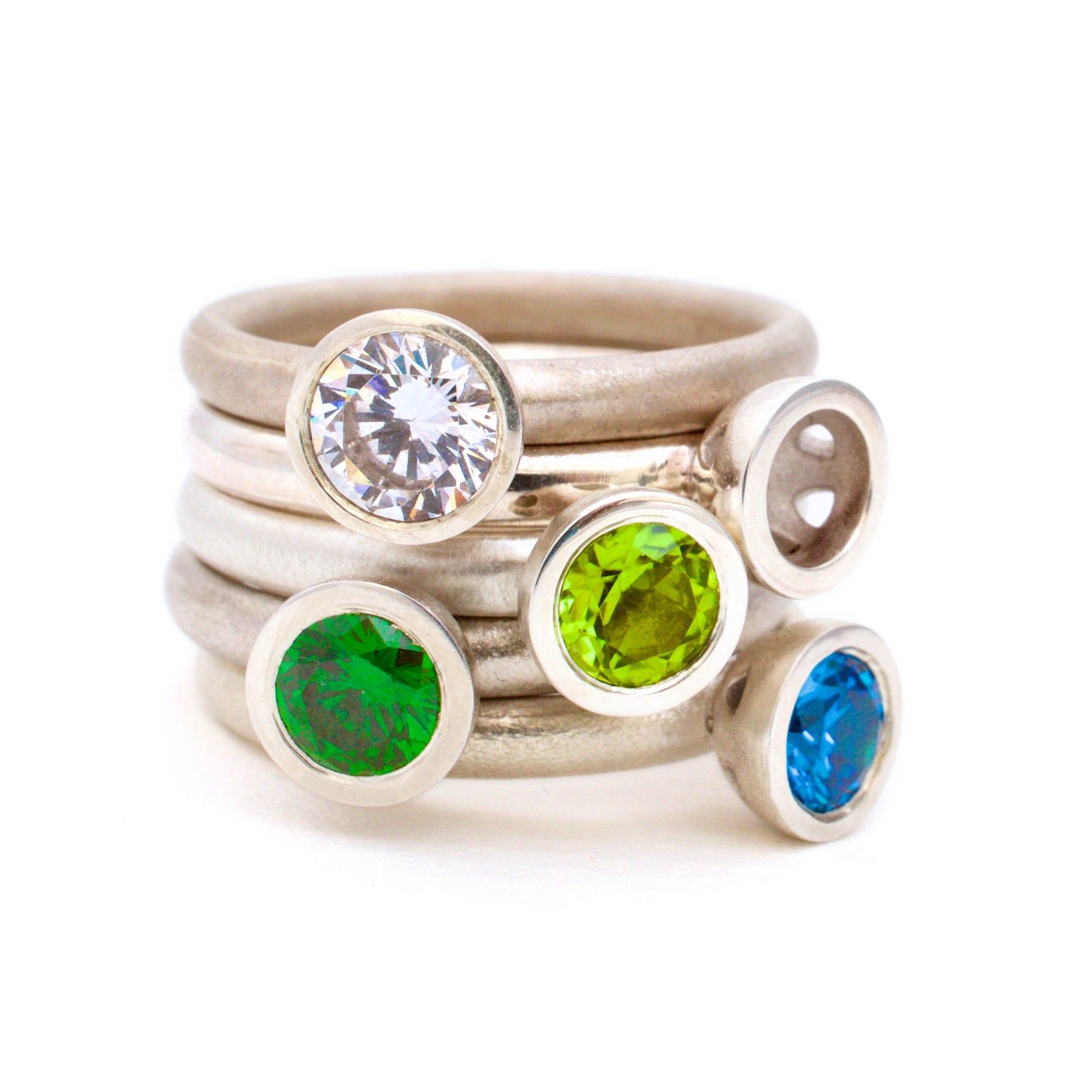 Kate Phipps Jewellery Scattered trillions rings silver with blue and green gemstones stacked square
