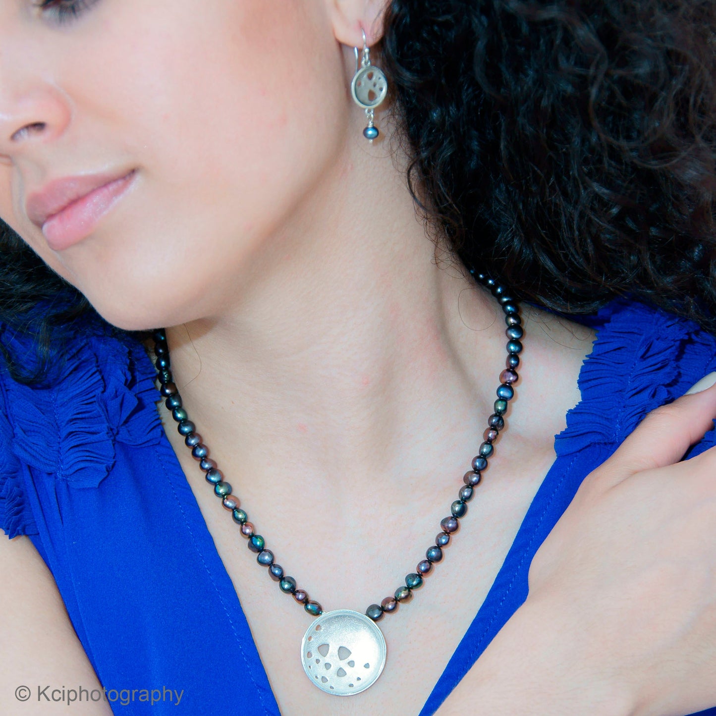 Kate Phipps Jewellery Scattered trillions set necklace large silver pendant on peacock pearl beads and drop silver earrings with peacock pearl drops model photo