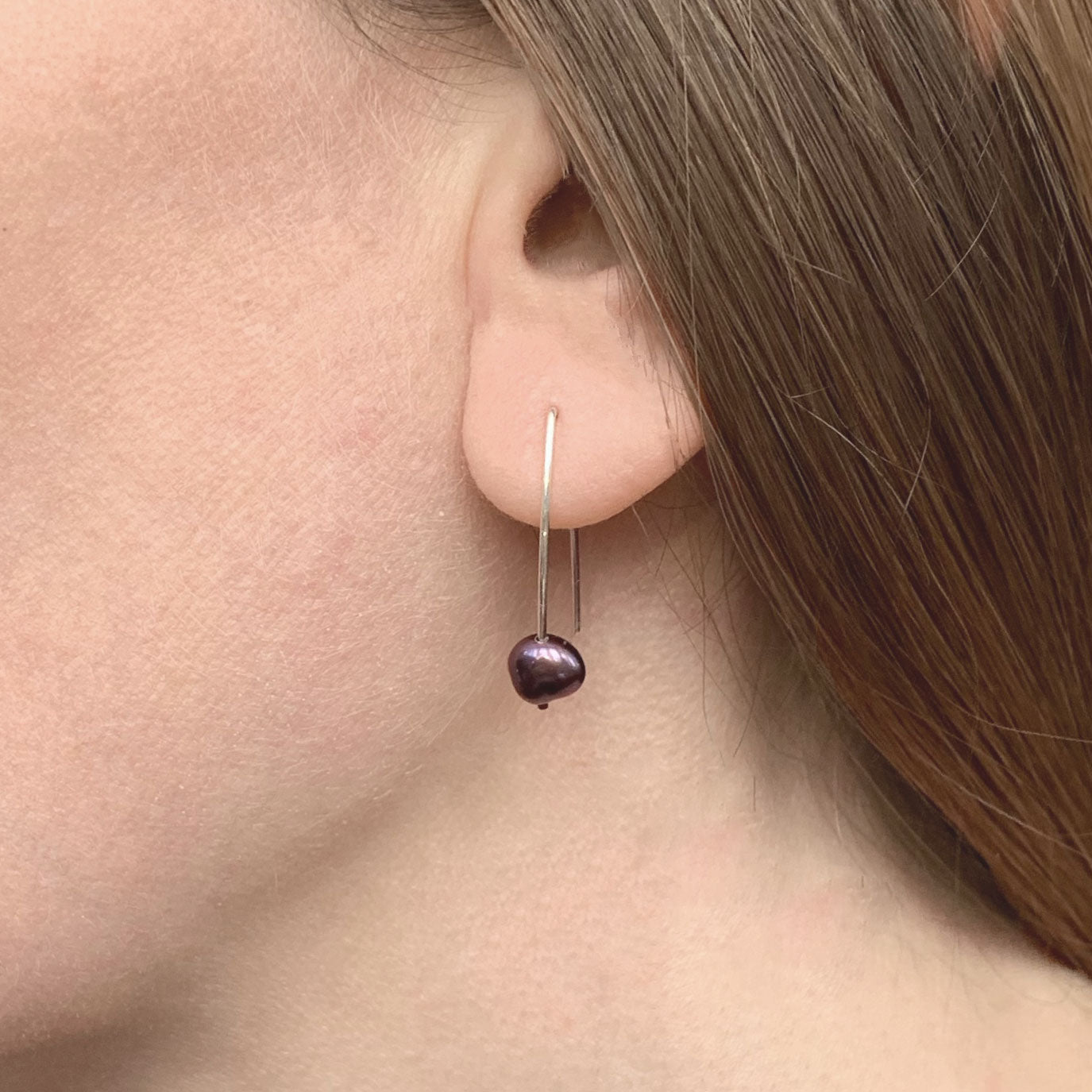 Kate Phipps Jewellery Simple elegance drop earrings long silver wire with peacock pearl model shot