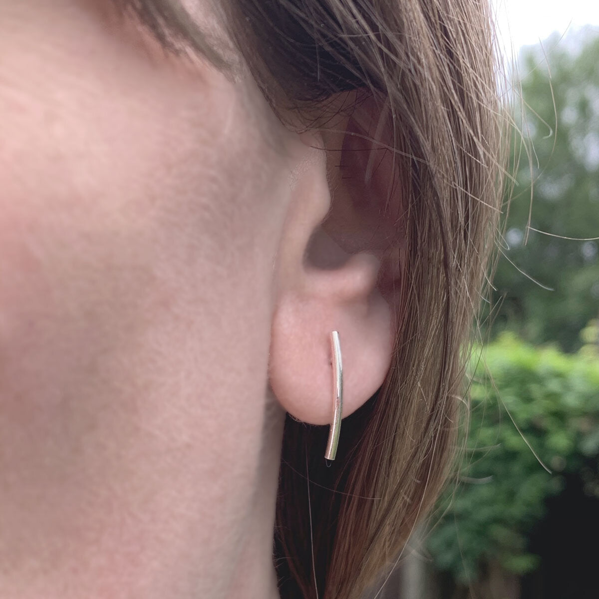 Kate Phipps Jewellery Simple elegance stud earrings medium curved polished silver model photo