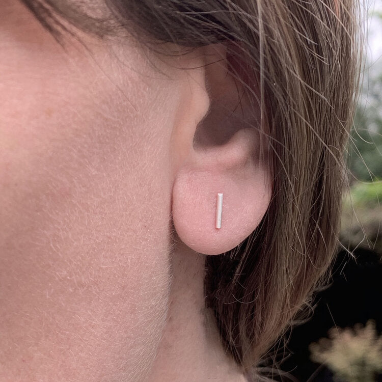 Kate Phipps Jewellery Simple elegance stud earrings short 8mm silver aligned vertically model photo