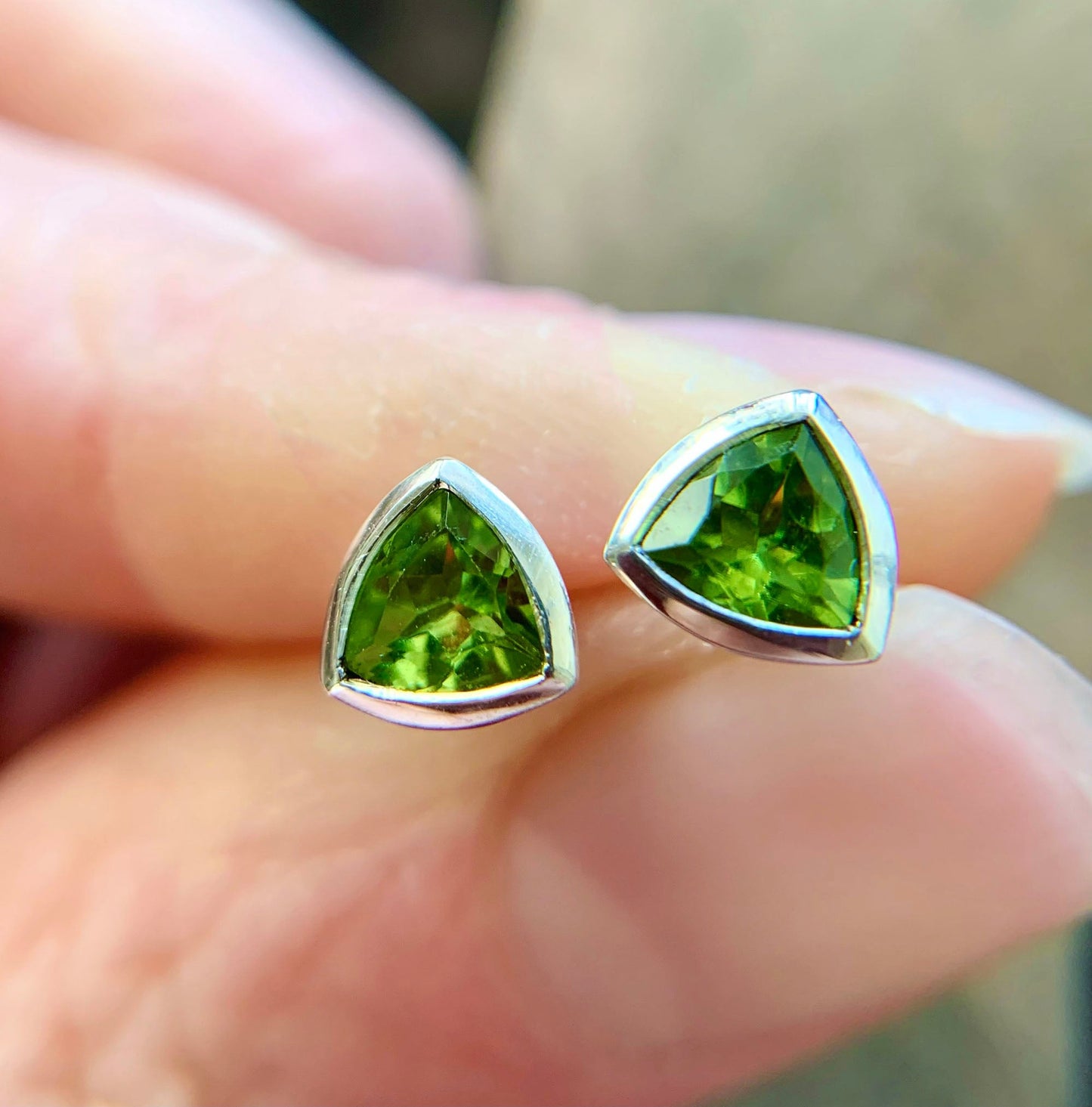 Kate Phipps Jewellery Single stone stud earrings silver with trillion cut peridot held in hand 1