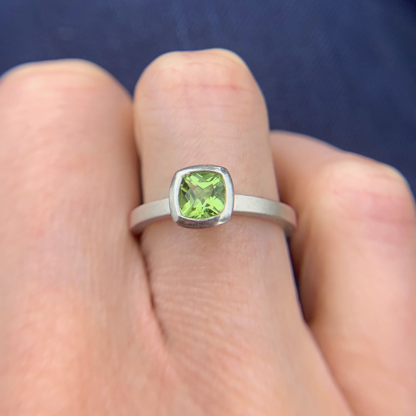 Kate Phipps Jewellery Solitaire ring cushion cut peridot set in silver model photo
