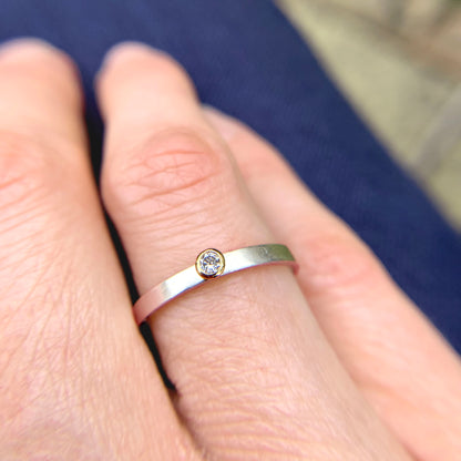 Kate Phipps Jewellery Solitaire ring salt and pepper diamond set in 18 carat yellow gold on a silver ring band model photo 1