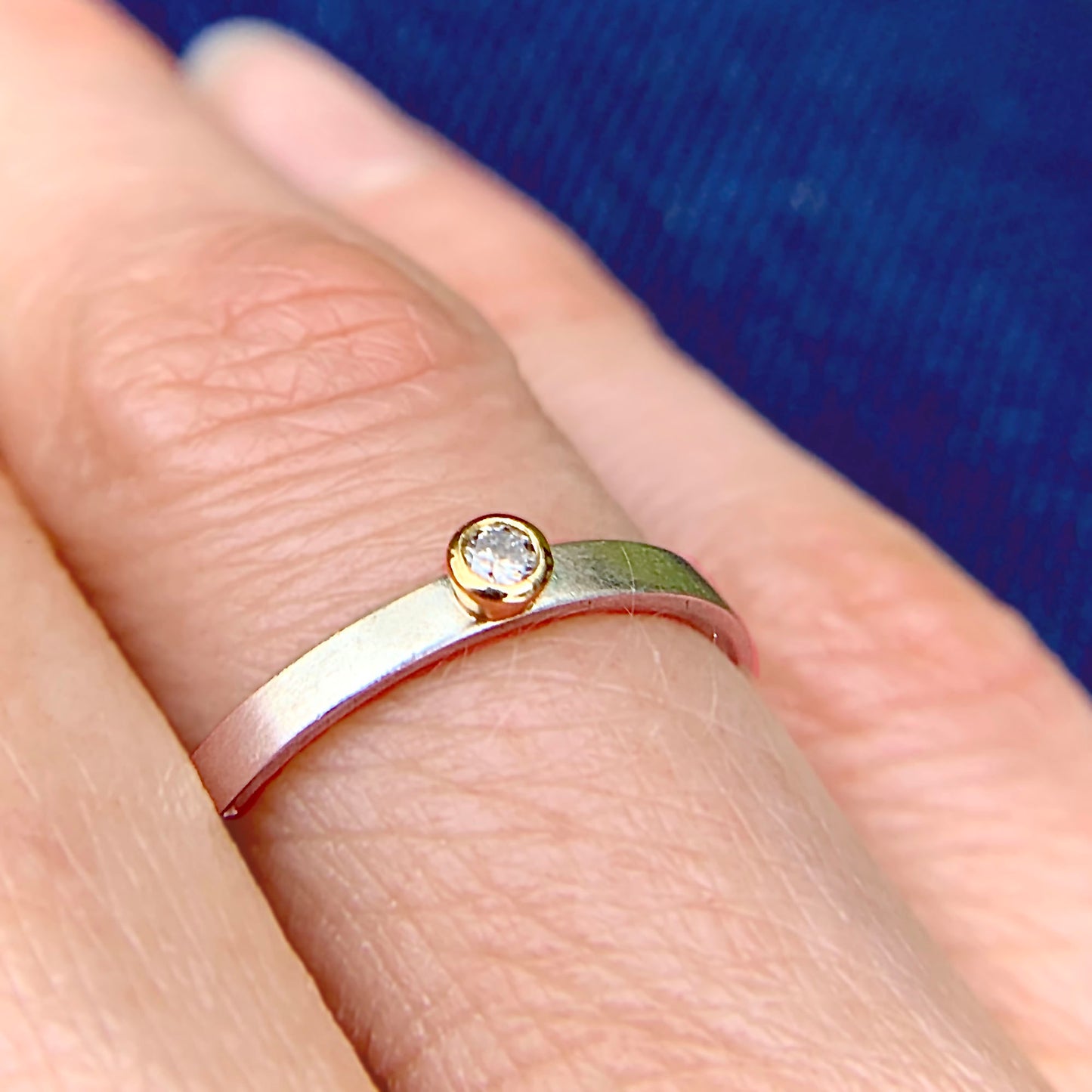 Kate Phipps Jewellery Solitaire ring salt and pepper diamond set in 18 carat yellow gold on a silver ring band model photo 2