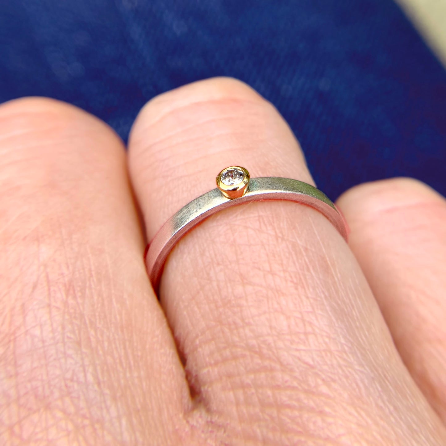 Kate Phipps Jewellery Solitaire ring salt and pepper diamond set in 18 carat yellow gold on a silver ring band model photo 3