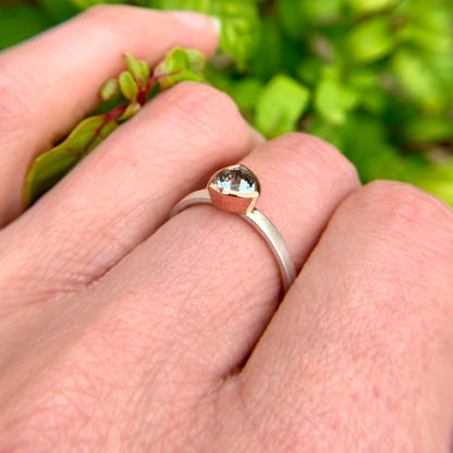 Kate Phipps Jewellery Solitaire ring trillion cut aquamarine set in 9 carat rose gold on a silver ring band model photo 4