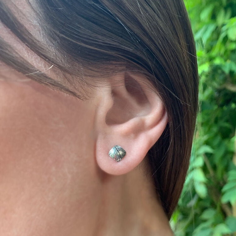 Kate Phipps Jewellery Square stud earrings convex oxidised leaf skeleton textured silver model photo