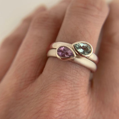 Kate Phipps Jewellery Stacking ring pair silver with pear shaped green beryl and pale amethyst pointing opposite directions points closer together model photo