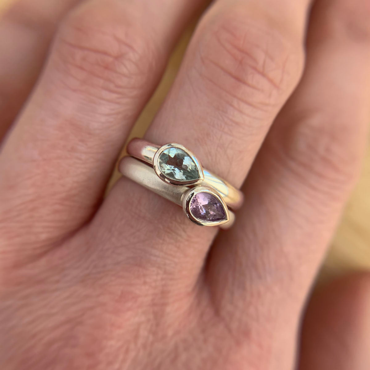 Kate Phipps Jewellery Stacking ring pair silver with pear shaped green beryl and pale amethyst pointing same direction model photo