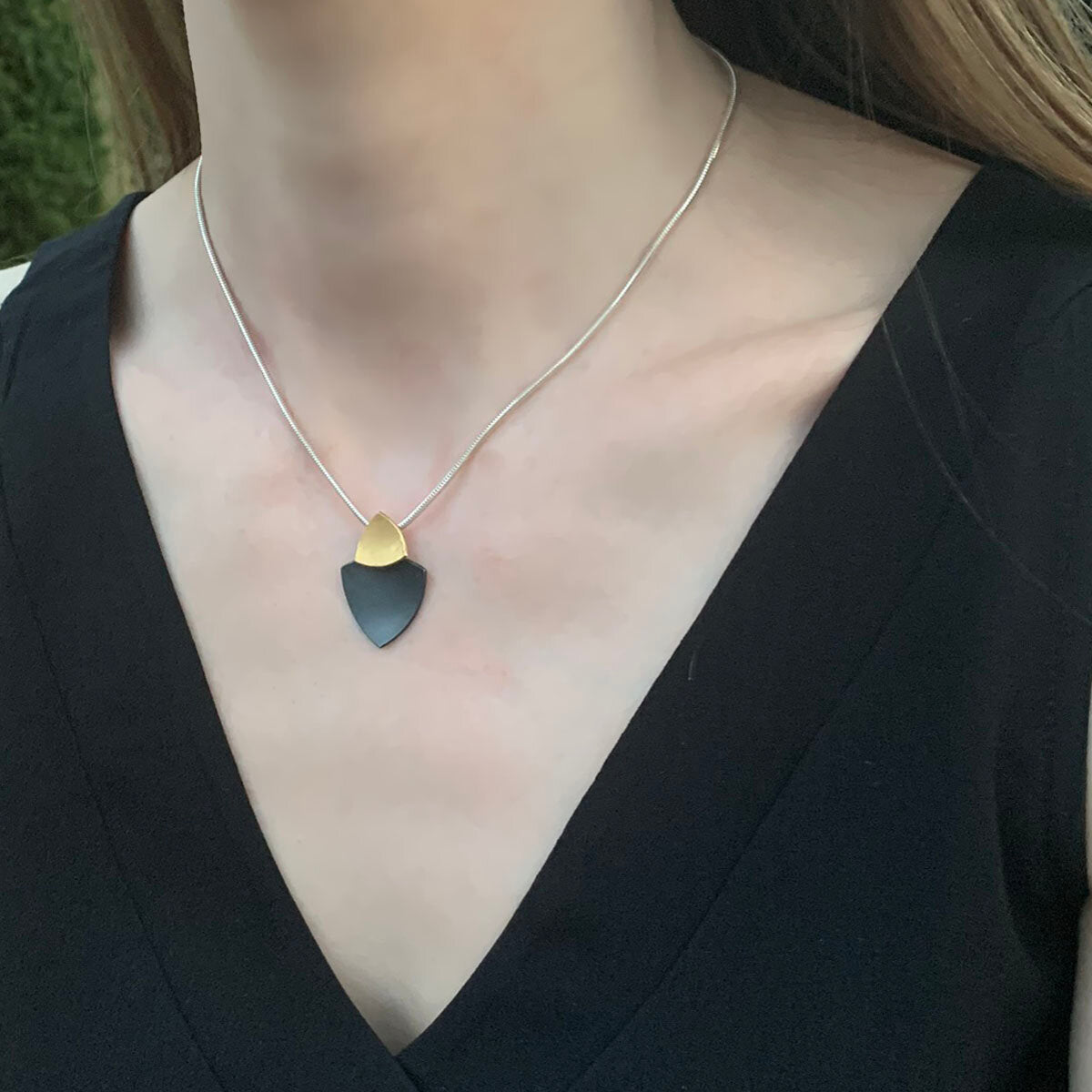 Kate Phipps Jewellery Trillion duo necklace 22 carat yellow gold plated silver top section and oxidised silver lower section concave side model photo 1