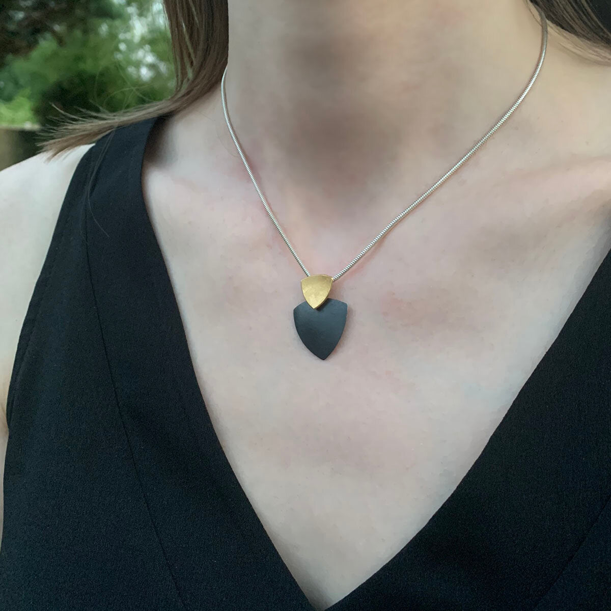 Kate Phipps Jewellery Trillion duo necklace 22 carat yellow gold plated silver top section and oxidised silver lower section convex side model photo 2