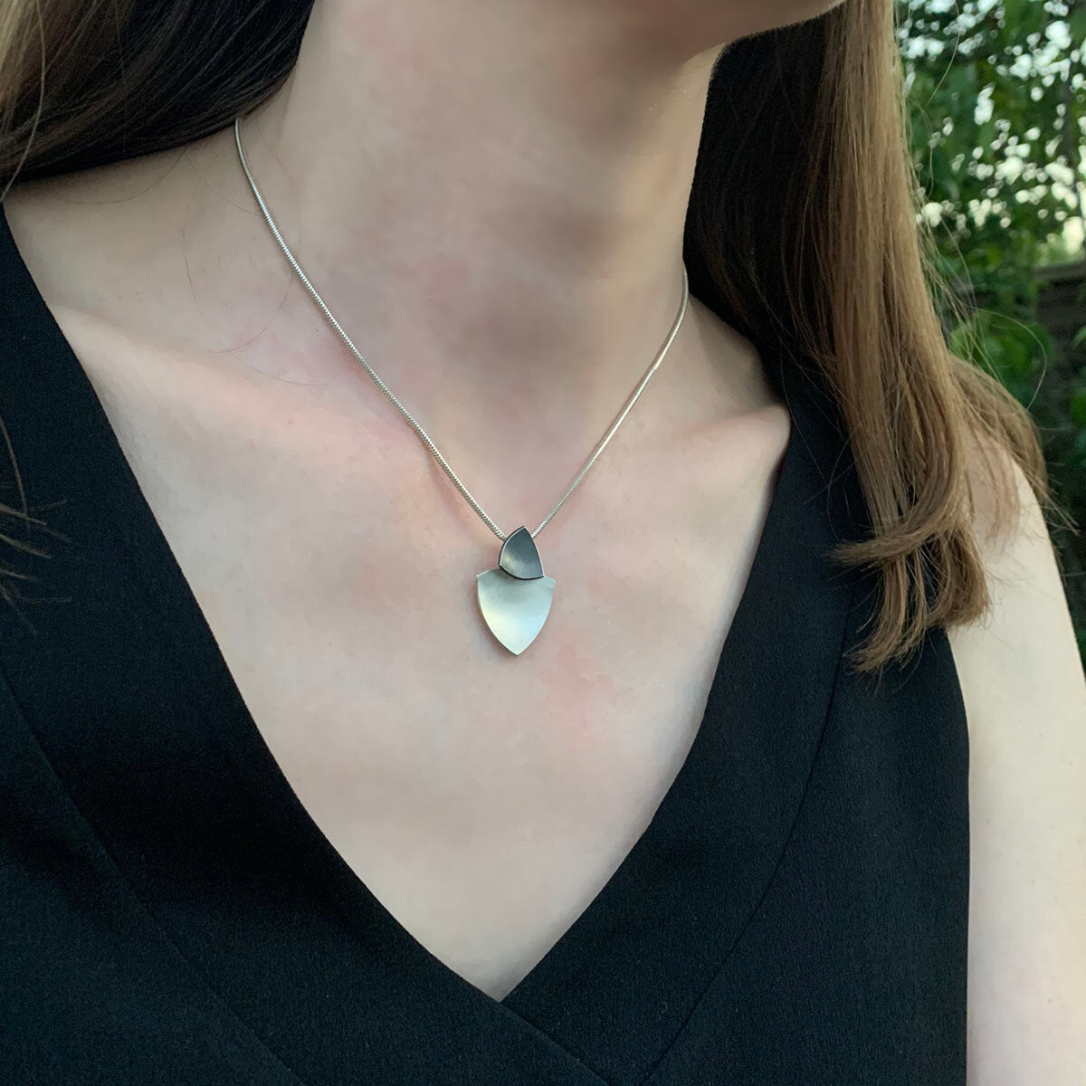 Kate Phipps Jewellery Trillion duo necklace oxidised silver top section and silver lower section concave side model photo 2